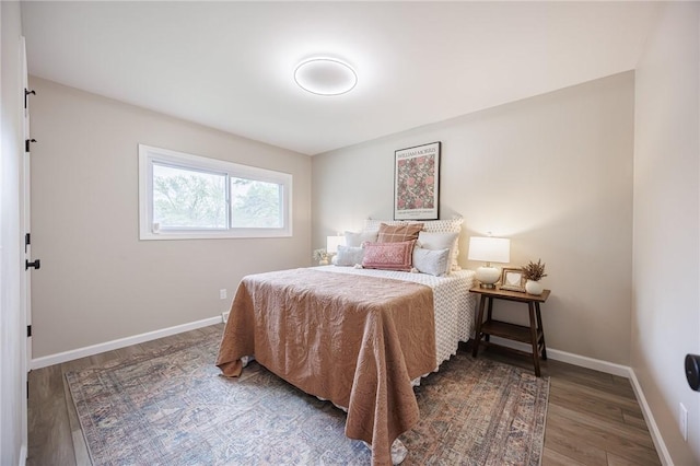bedroom with wood finished floors and baseboards