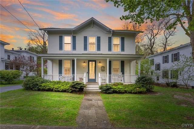 view of front facade featuring a front lawn and covered porch