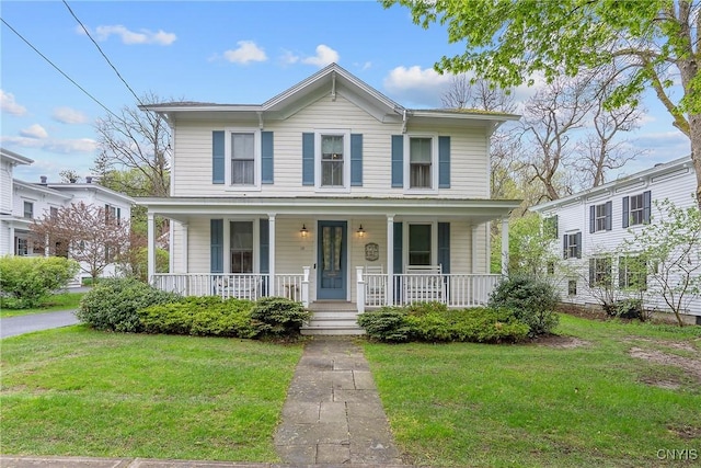 view of front of home featuring a front yard and a porch