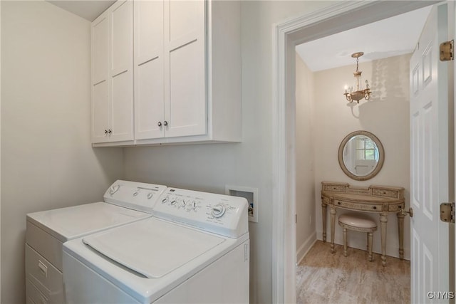 clothes washing area featuring cabinet space, separate washer and dryer, light wood-style flooring, and baseboards