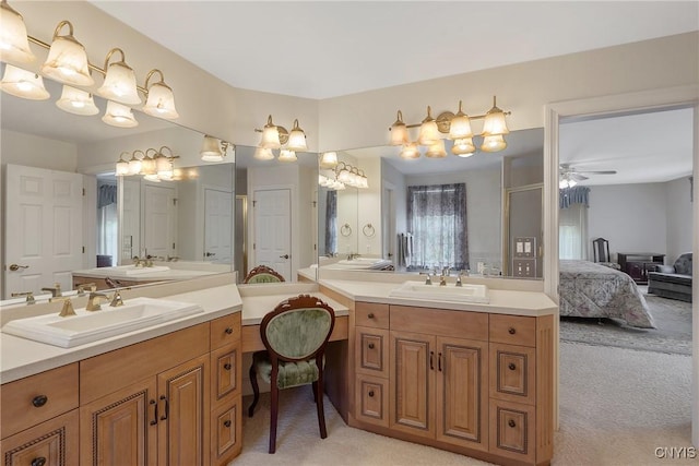 bathroom with a ceiling fan, ensuite bathroom, and two vanities