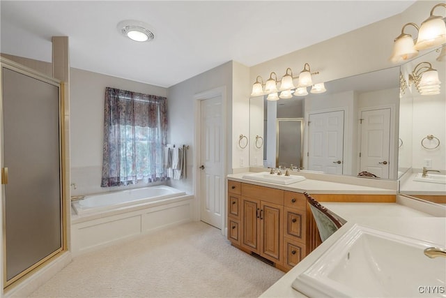 bathroom with a stall shower, a garden tub, and vanity