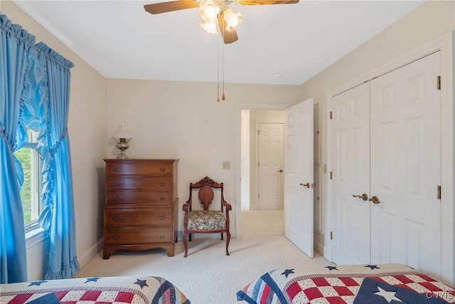 bedroom with a closet, carpet, a ceiling fan, and baseboards