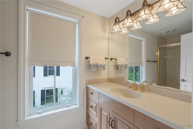 bathroom with vanity and a shower with shower door