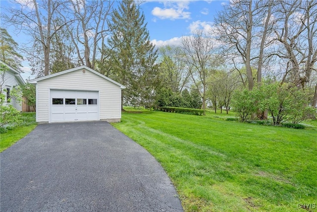 detached garage with asphalt driveway