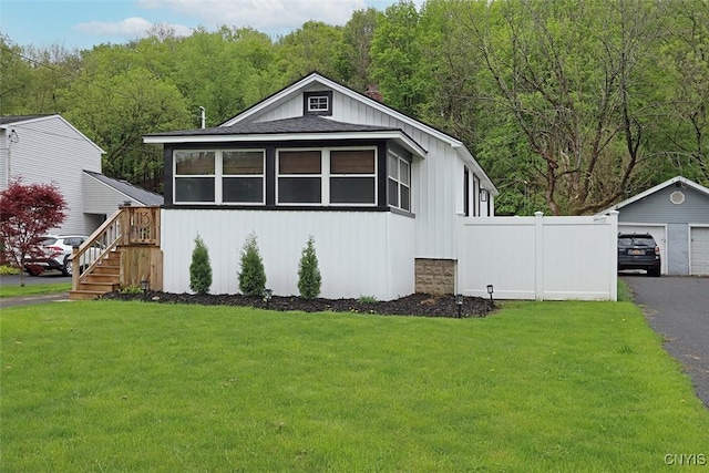 113 Olmstead Pl, Onondaga, NY 13219 - view of front of home with an outbuilding, roof with shingles, a view of trees, and stairway