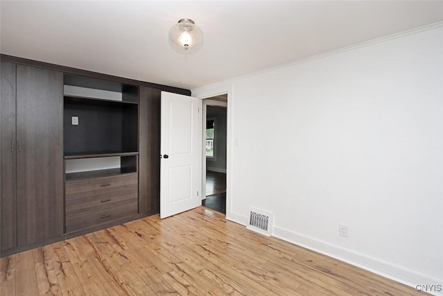 113 Olmstead Pl, Onondaga, NY 13219 - unfurnished bedroom featuring light wood-type flooring, baseboards, and crown molding