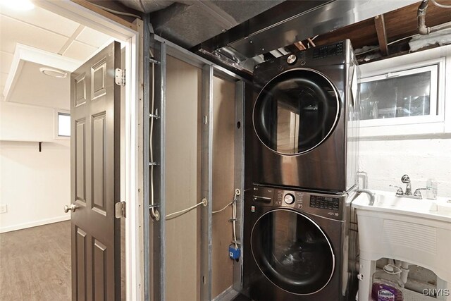 113 Olmstead Pl, Onondaga, NY 13219 - clothes washing area with stacked washer / drying machine, wood finished floors, and baseboards