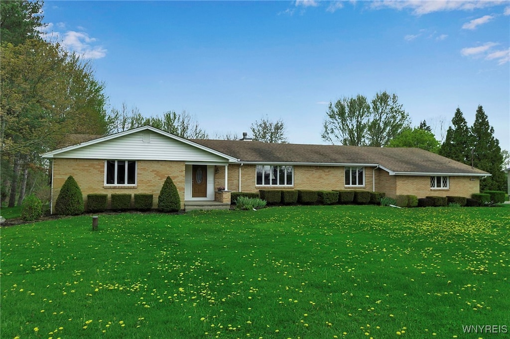 ranch-style home with brick siding and a front lawn