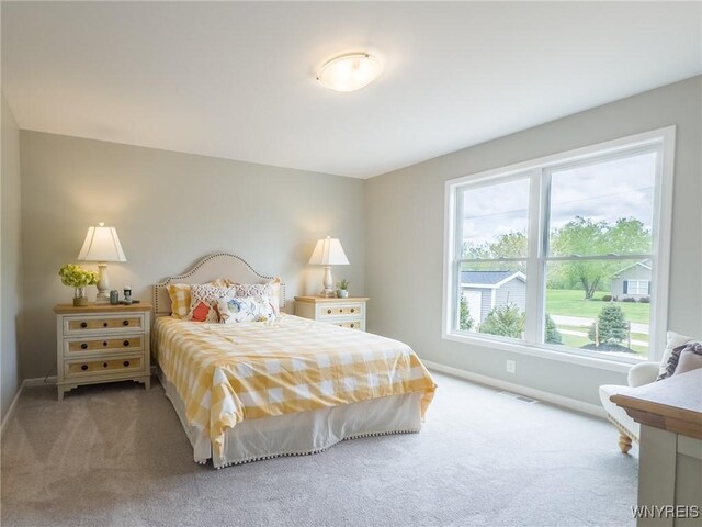 carpeted bedroom featuring baseboards