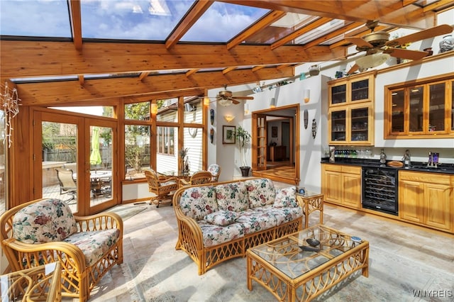 living area featuring wine cooler, a ceiling fan, and wet bar