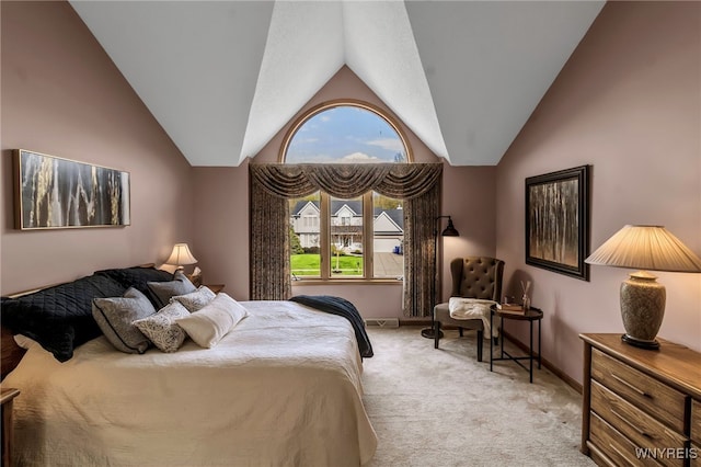 bedroom featuring light colored carpet, vaulted ceiling, and baseboards