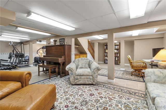 living area featuring stairway and tile patterned flooring