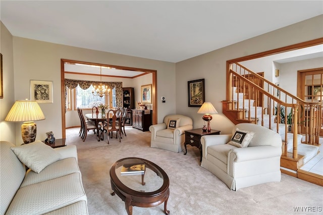 living area with a chandelier, light colored carpet, and stairs
