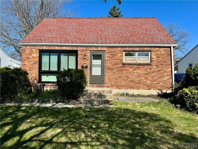 88 Loretto Dr, Cheektowaga, NY 14225 - view of front of home featuring brick siding, entry steps, roof with shingles, and a front lawn