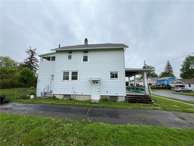324 W Ave, Elmira-City, NY 14904 - rear view of house featuring fence and a chimney