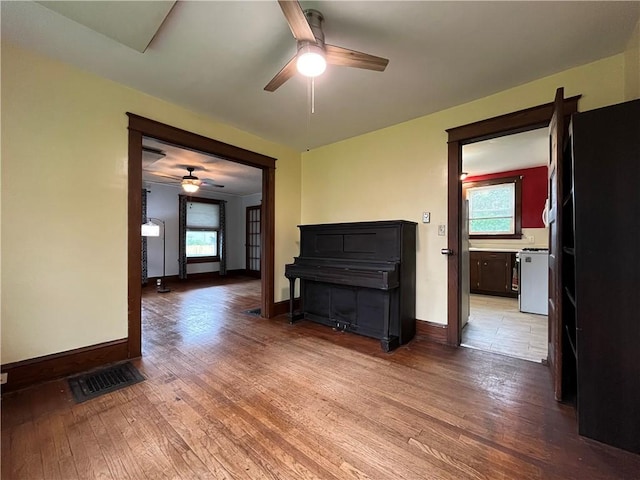 324 W Ave, Elmira-City, NY 14904 - unfurnished living room with a ceiling fan, wood finished floors, and baseboards