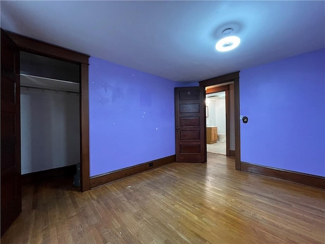 324 W Ave, Elmira-City, NY 14904 - unfurnished bedroom featuring wood finished floors, baseboards, and a closet