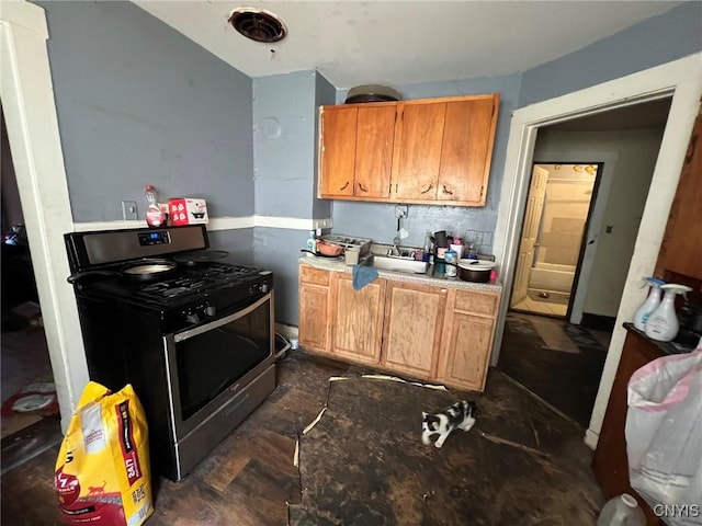 413 Fitch St, Syracuse, NY 13204 - kitchen with gas range, light countertops, and brown cabinets