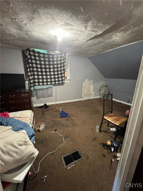 413 Fitch St, Syracuse, NY 13204 - unfurnished bedroom featuring vaulted ceiling and baseboards