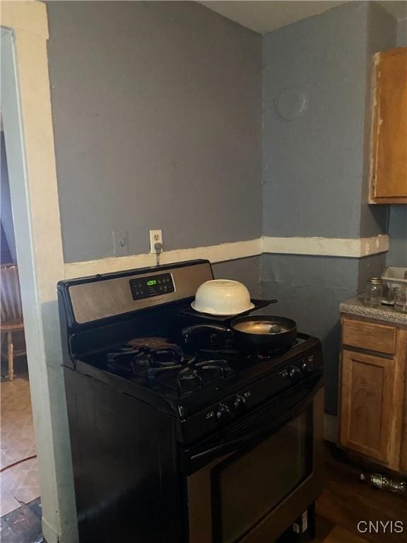413 Fitch St, Syracuse, NY 13204 - kitchen featuring gas stove and brown cabinets