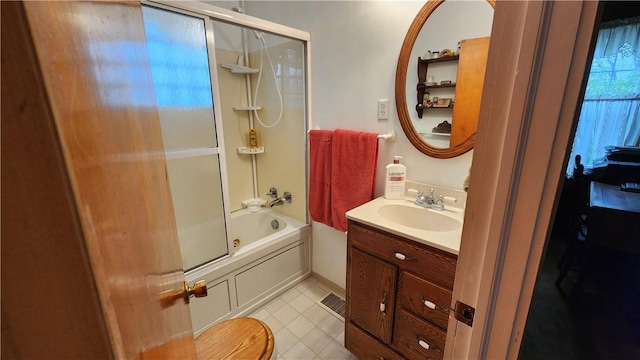 full bathroom featuring vanity, combined bath / shower with glass door, and tile patterned flooring