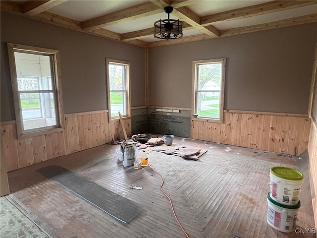 109 Mechanic St, Antwerp, NY 13608 - unfurnished room featuring a wainscoted wall, plenty of natural light, wood walls, beam ceiling, and coffered ceiling