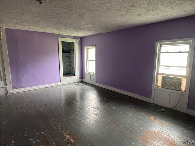 109 Mechanic St, Antwerp, NY 13608 - empty room featuring hardwood / wood-style floors, cooling unit, baseboards, and a textured ceiling