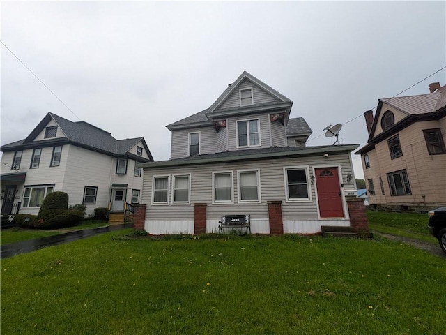 rear view of house with a lawn and entry steps
