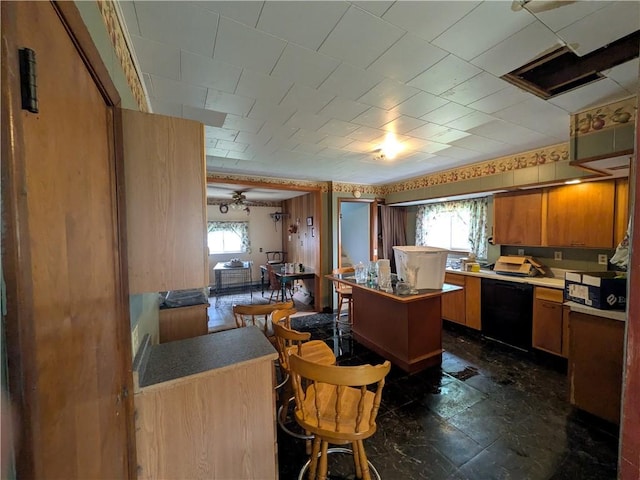 kitchen with brown cabinets, dishwasher, and light countertops