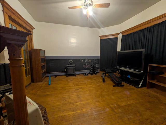 workout area featuring hardwood / wood-style flooring and a ceiling fan