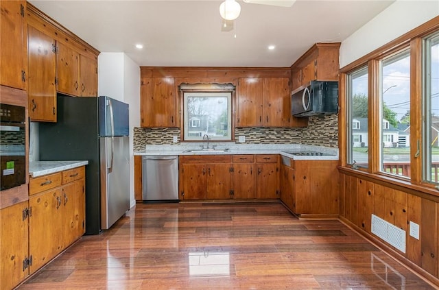 134 Schum Ln, Rochester, NY 14609 - kitchen featuring black appliances, brown cabinetry, a sink, and recessed lighting
