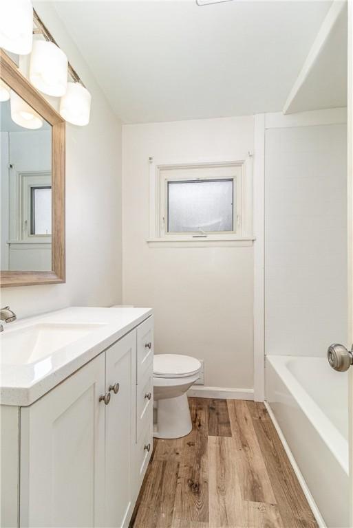 134 Schum Ln, Rochester, NY 14609 - full bathroom with wood finished floors, toilet, and vanity
