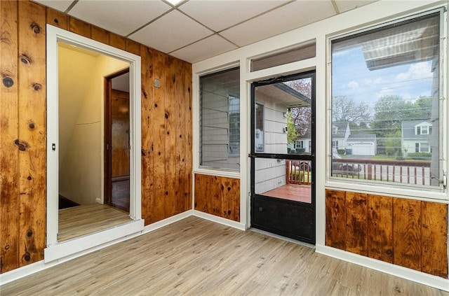 134 Schum Ln, Rochester, NY 14609 - spare room with wood finished floors, baseboards, wooden walls, and a drop ceiling