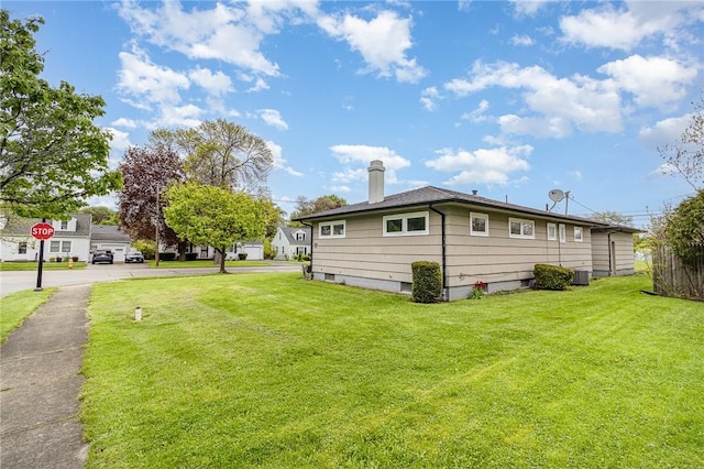 134 Schum Ln, Rochester, NY 14609 - view of property exterior with a chimney, a yard, and central air condition unit