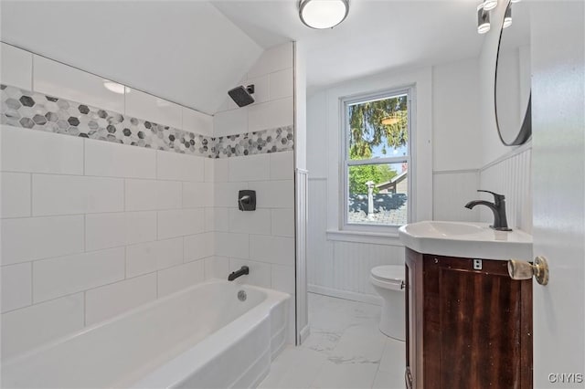 bathroom featuring marble finish flooring, toilet,  shower combination, vanity, and vaulted ceiling