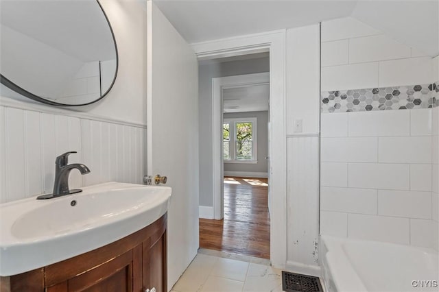 full bath featuring vanity and wainscoting
