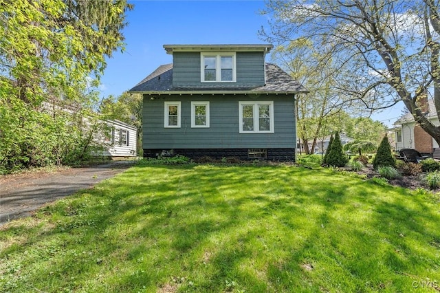 back of property with a lawn