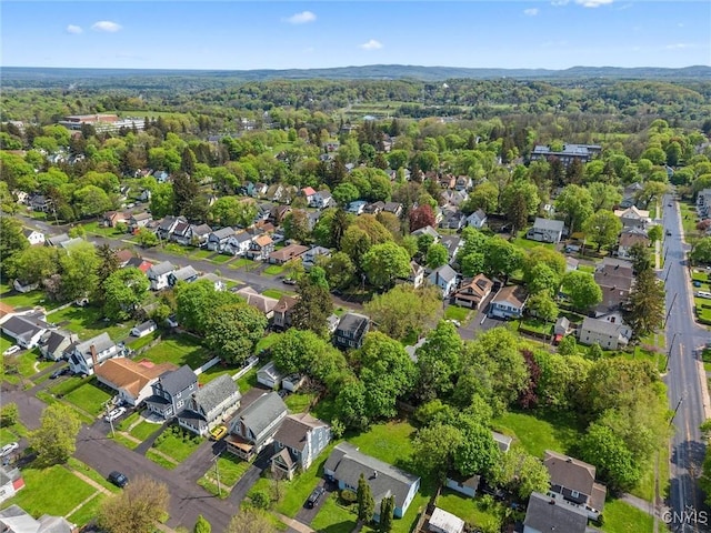 aerial view of property's location with nearby suburban area and a forest