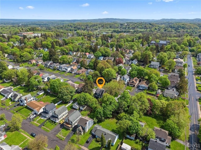 aerial view of property's location with nearby suburban area and a forest