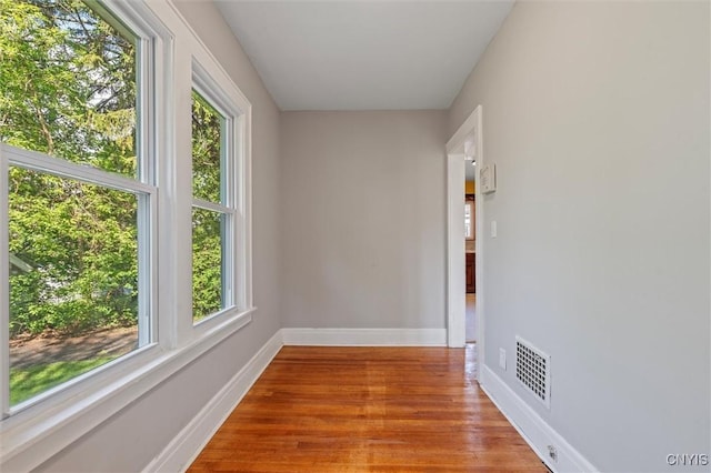 hall with wood finished floors and baseboards
