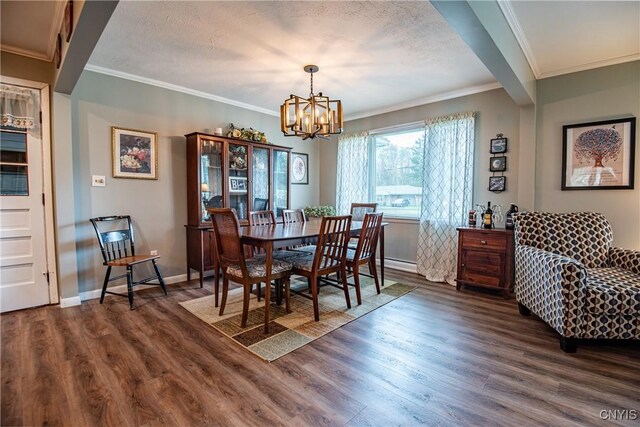 7732 Gifford Rd, Rome-Inside, NY 13440 - dining area featuring dark wood-style flooring, a chandelier, crown molding, baseboards, and a textured ceiling
