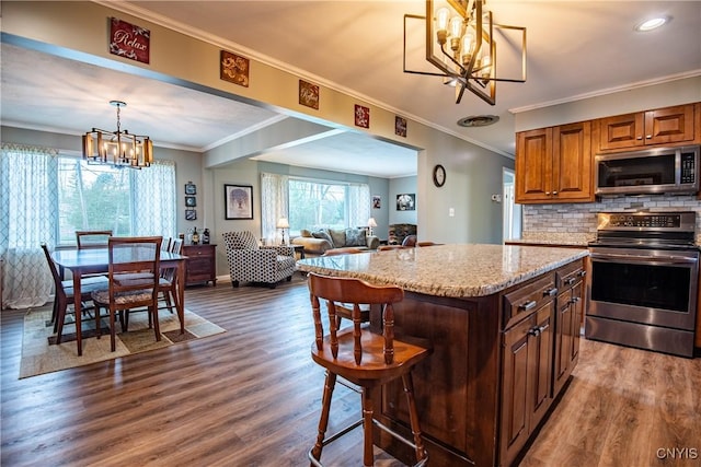 7732 Gifford Rd, Rome-Inside, NY 13440 - kitchen featuring appliances with stainless steel finishes, a chandelier, dark wood-style flooring, light stone counters, and crown molding