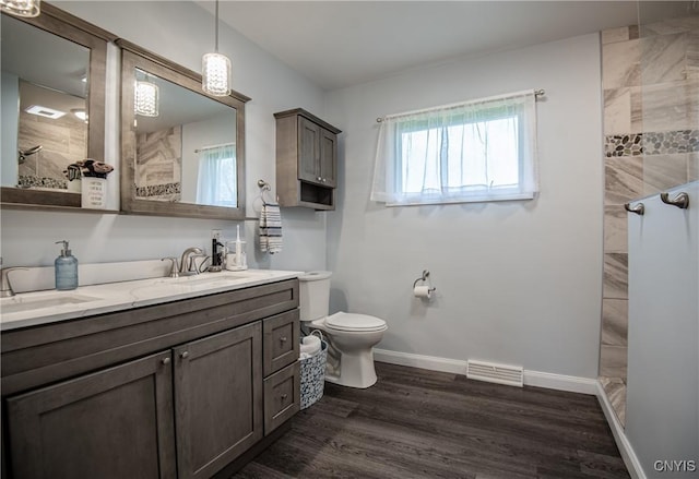 7732 Gifford Rd, Rome-Inside, NY 13440 - bathroom with walk in shower, toilet, wood finished floors, double vanity, and baseboards