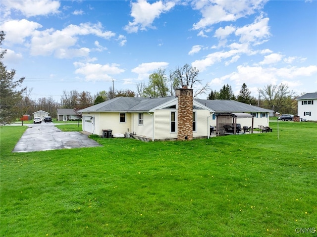 7732 Gifford Rd, Rome-Inside, NY 13440 - back of house featuring a chimney and a lawn