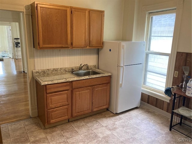 313-315 Whittier Ave, Syracuse, NY 13204 - kitchen featuring a sink, freestanding refrigerator, light countertops, and brown cabinets