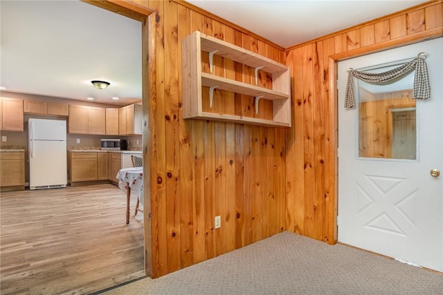 mudroom with wood walls