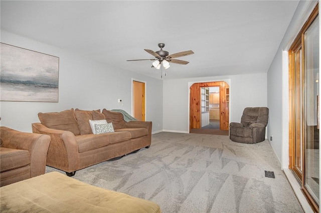 carpeted living area featuring ceiling fan