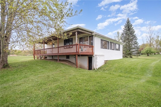 rear view of house with a lawn and a deck