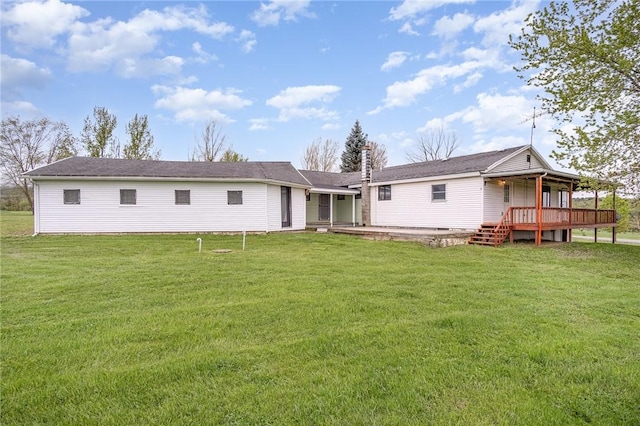 back of property with a lawn and a wooden deck